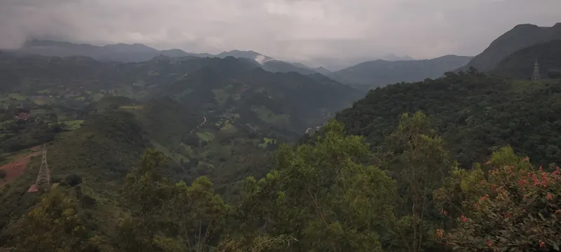 Cloud over green hills and a valley, seen from the Galikonda viewpoint in Araku Valley