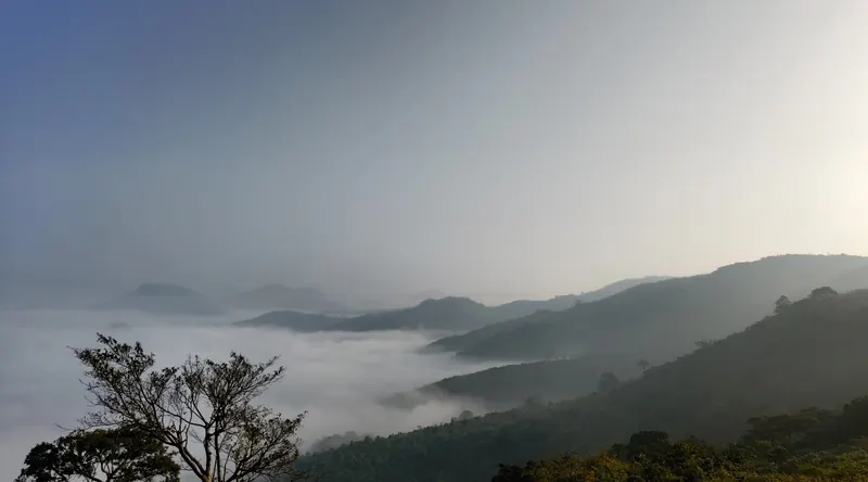 Morning clouds filling the valleys below hills near Lambasingi